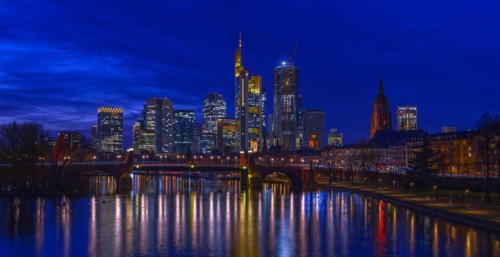 The Frankfurt skyline with office tower blocks behind the Main at blue hour after sunset, on the