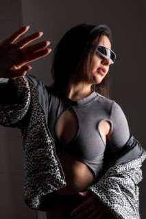 Studio portrait with grey background of a beauty woman gesturing using futuristic intelligent