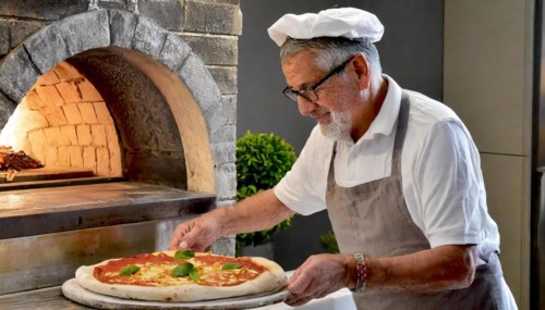 Pizza baker in Naples, Italy, preparing a pizza, in front of the pizza oven, AI generated, AI