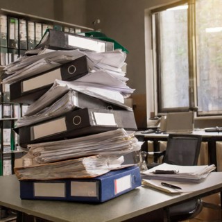 High stacks of files and piles of paper organised on office filing areas, symbolism bureaucracy, AI
