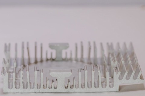 Closeup of fins of rectangle aluminum heat sink on white background