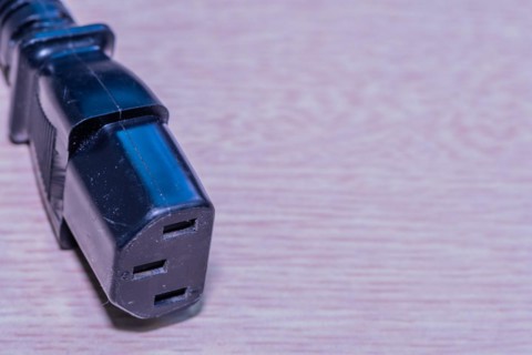 Closeup of computer power cord. This end plugs into device