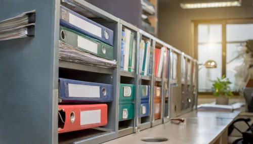 Metal shelf with sorted files next to a desk in the office, symbolism bureaucracy, AI generated, AI