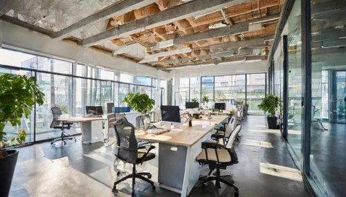 Open office design with natural wooden beams and green accents emphasises a modern style, symbol