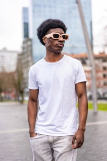 Vertical photo of a handsome african cool man in summer white clothes in the city