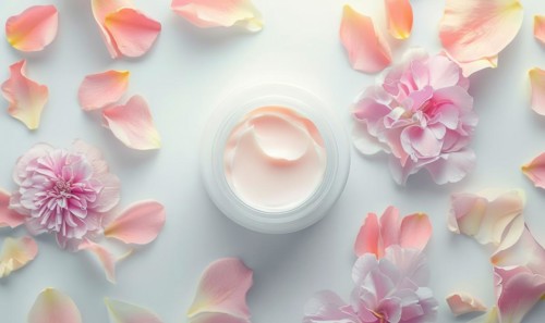 Blank creme jar mockup encircled by pastel flower petals on a white background, top view AI