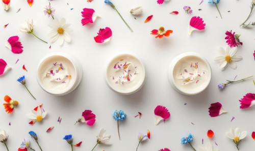Three creme jar blank mockups nestled amidst delicate flower petals on a white background AI
