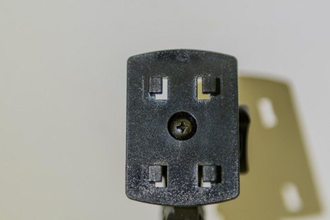 Closeup of car navigation mounting plate and its shadow on white background
