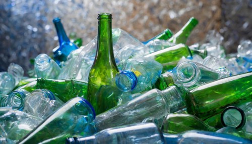 Used glass in a pile, only empty bottles, in a recycling plant, AI generated, AI generated