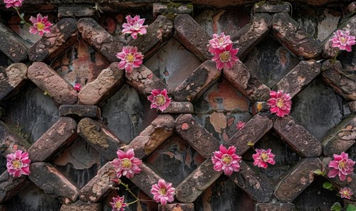Pink flowers erupting through a diagonal brick pattern on a wall AI generated