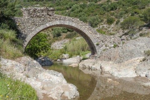 Historic arch bridge Le Pont des Fees over the river La Garde, Grimaud-Village, Var,