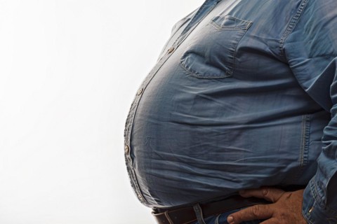 Close up of fat belly of heavily obese man in shirt on white background. KI generiert, generiert,