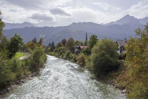 Loisach with houses, old parish church St. Martin, Wetterstein mountains with alpine seats,