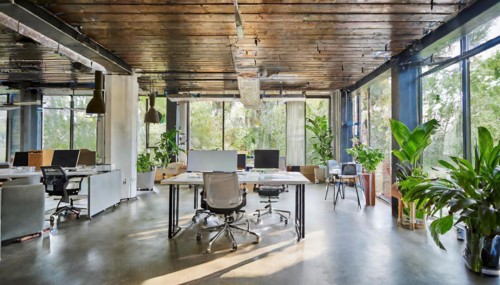 Open-plan office with industrial design and wooden elements exudes an urban atmosphere, symbol