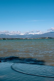 View over the wavy Lake Garda under a blue sky with clouds, Sirmione, Lake Garda, Italy, Europe