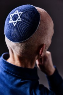 Jewish man wearing a kippa with a Star of David on his head, back view, studio shot, Germany,