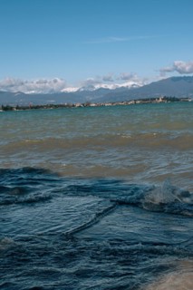 View over the wavy Lake Garda under a blue sky with clouds, Sirmione, Lake Garda, Italy, Europe