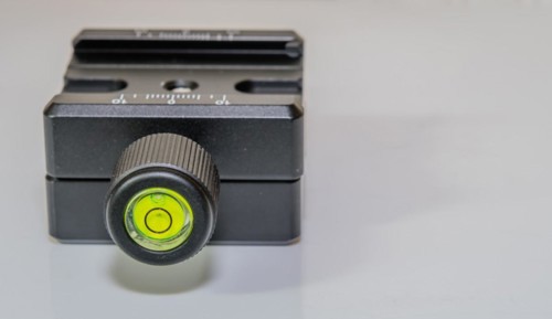 Closeup of bubble level inside locking knob of lock type camera mount for use on tripod