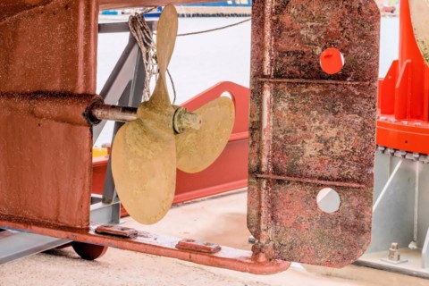 Rusty ship propeller on dry dock, showcasing textures of marine wear and tear, in Ulsan, South