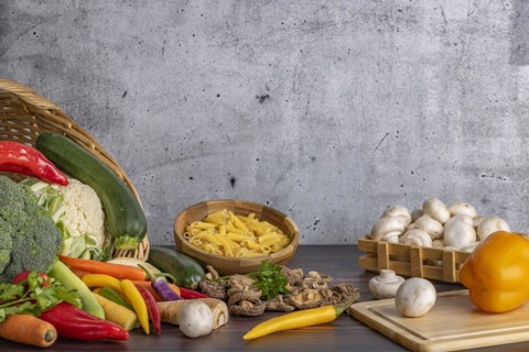 Various fresh vegetables such as peppers, cauliflower, peppers, mushrooms and broccoli around and