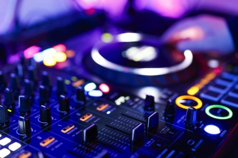 Hand of a DJ on a mixing desk, also called DJ controller or DJ console, at a party, Cologne, North