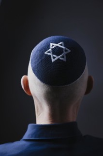 Jewish man wearing a kippa with a Star of David on his head, back view, studio shot, Germany,