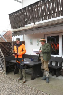 Wild boar (Sus scrofa) Hunting master and professional hunter give a speech in front of the start