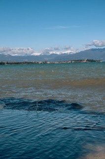 View over the wavy Lake Garda under a blue sky with clouds, Sirmione, Lake Garda, Italy, Europe