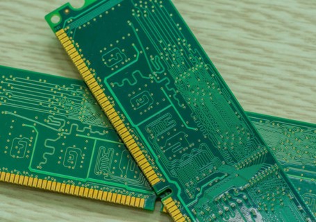 Several RAM modules placed together showcasing their gold contacts and green circuitry, in South