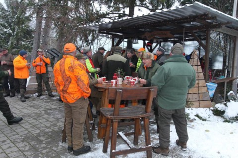 Wild boar (Sus scrofa) end of the hunt, amusing hunter's round, so-called Schuesseltreiben,