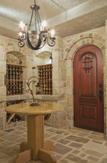 Medieval style beige and tan cut stone wine cellar in basement inside elegant style home, Quebec,