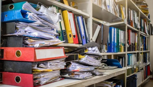 Many cluttered and chaotic files on shelves in an office, symbol bureaucracy, AI generated, AI