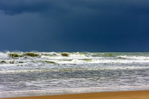 Dark rain clouds over the waters of Sargi beach in Serra Grande on the coast of Bahia, Bahia,