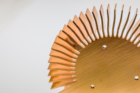 Closeup of mounting surface of round copper heat sink on white background
