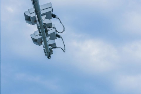 Speed radar cameras mounted on metal pole against blue sky with puffy white clouds in Daejeon,
