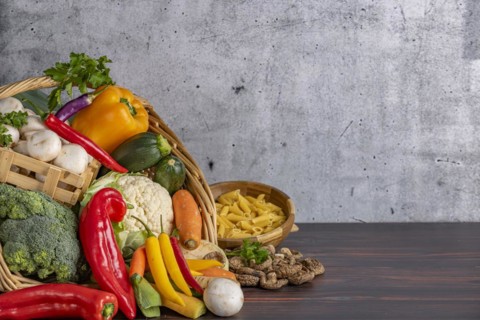 Various fresh vegetables such as peppers, cauliflower, peppers, mushrooms and broccoli in a basket