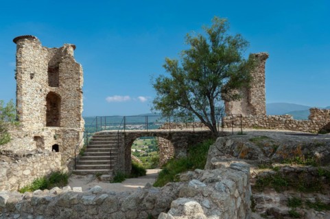 Ruins of Grimaud Castle with a view of the village of Grimaud, in the background the hills of the