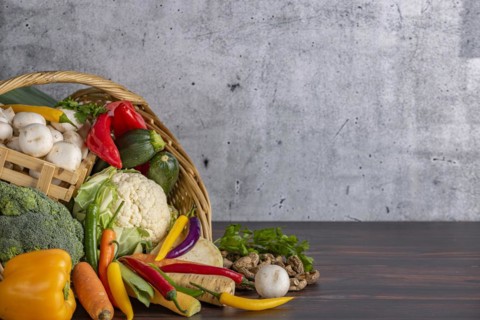 Various fresh vegetables such as peppers, cauliflower, peppers, mushrooms and broccoli in a basket