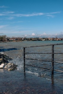 Splashing waves hitting rocks on the shore of Lake Garda, Sirmione, Lake Garda, Italy, Europe