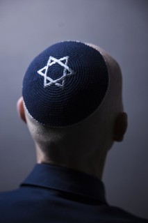 Jewish man wearing a kippa with a Star of David on his head, back view, studio shot, Germany,