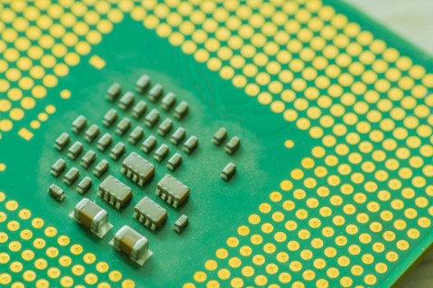 Extreme closeup of Central processor unit (CPU) detailing the individual chips and gold connection