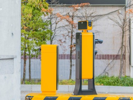 Side view of device to read license plates and calculate charges as cars enter and exit parking