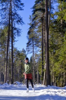 Ice skater, ice path through the forest, Sur En, Sent near Scuol, Engadin, Switzerland, Europe