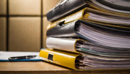 A large pile of files with black covers on a table, symbolising bureaucracy, AI generated, AI