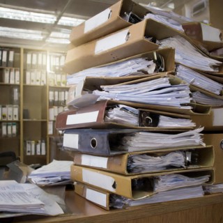 Piles of files and folders chaotically lined up in an office, symbolism bureaucracy, AI generated,