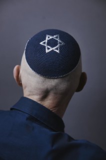 Jewish man wearing a kippa with a Star of David on his head, back view, studio shot, Germany,