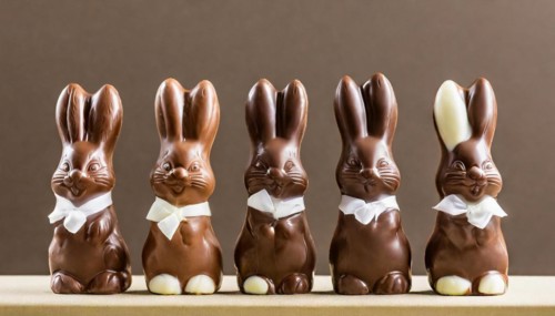 Brown chocolate bunnies with white flies in a row, Easter symbol, AI generated, AI generated