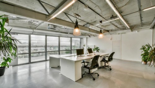 Stylish office with industrial elements and view to the outside through large glass front, symbol