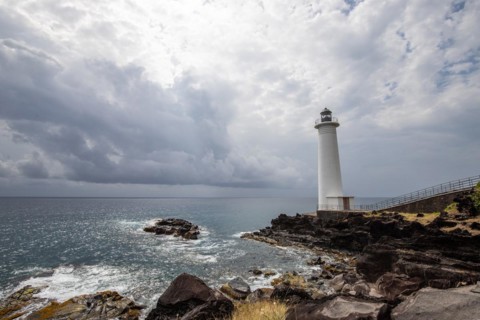 Le Phare du Vieux-Fort, white lighthouse on a cliff. Dramatic clouds with a view of the sea. Pure