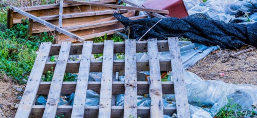 A chaotic pile of garbage with wood, plastic, and various debris, in South Korea